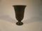 A Wedgwood black basalt flared vase with neo classical frieze