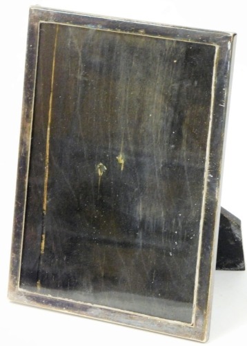 A 20thC photograph frame, of plain rectangular form with ebonised strut support, marked P. PAT25474, white metal, unmarked, 20cm high, 15cm wide.