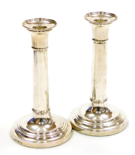 A pair of loaded silver candlesticks, of cylindrical form, London 2010, 18cm high, 18.86oz all in.