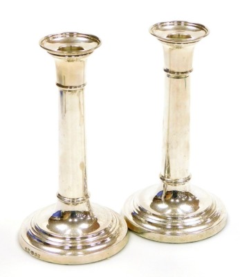 A pair of loaded silver candlesticks, of cylindrical form, London 2010, 18cm high, 18.86oz all in.