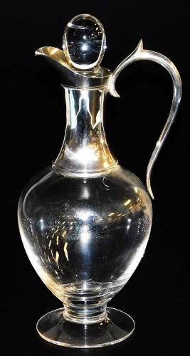 A late 20thC glass claret jug, of baluster form, with a silver collar and handle, J A Campbell, London 1997, 32cm high.