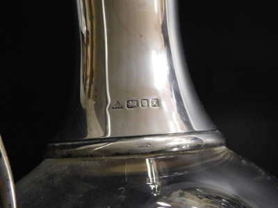 A late 20thC glass claret jug, of baluster form, with a silver collar and handle, J A Campbell, London 1997, 32cm high. - 2