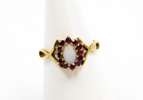 A 9ct gold dress ring, central cluster set with opal and garnet on twist shoulders, ring size N, 1.8g all in.