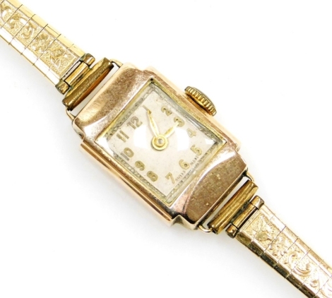 A lady's wristwatch, with 9ct gold square set wristwatch head, on a plated strap, 10.7g all in.