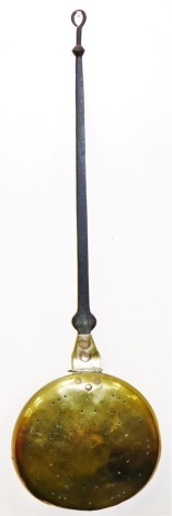 A George III brass warming pan, the pan with pierced decoration, with a shaped wrought iron handle, 95cm long.