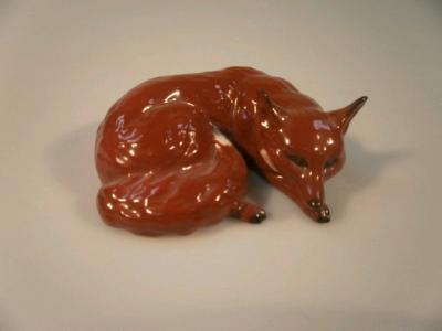 A Beswick curled pottery fox