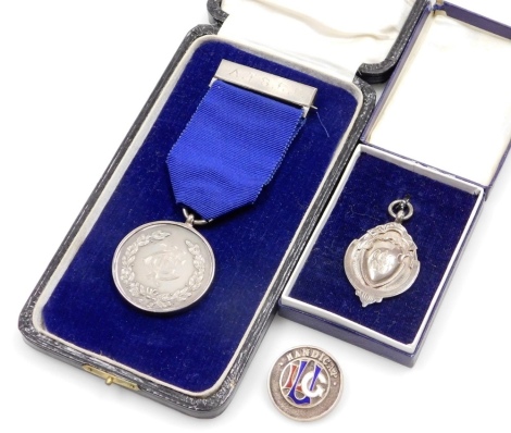 Three items of small silver, a London Schools Cadet Brigade 2nd long jump 1925 fob, Birmingham 1924, boxed, a silver and enamel handicap pin badge, Birmingham 1913, and a A.T.S.C.C.medal awarded to C.G. Forteath C.S.M. 1924, with purple ribbon, Birmingham