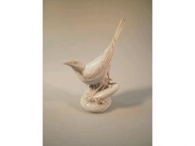 A Meissen factory second porcelain figure of a bird on a circular base