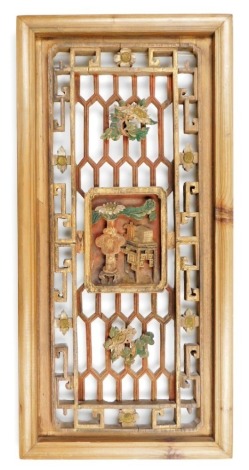 A Qing dynasty pierced lattice wood Buddhist panel, of rectangular form carved with a vase containing a flower, and an alter table, painted in muted tones and gilded, 61cm high, 29.5cm wide.