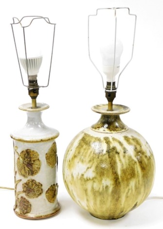 A studio pottery globular table lamp base with brass fitting, the lamp 31cm high, and another studio pottery table lamp of cylindrical form, relief decorated with water lilies. (2)