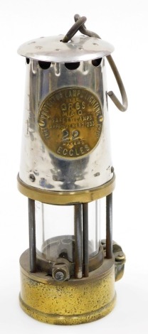 A Protector Lamp Lighting Co Ltd miner's lamp, stamped number 22, in steel and brass, 23cm high.