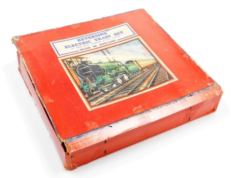 A tin plate battery operated reversing electric O gauge train set, the locomotive, no 490, and tender in LNER livery with two carriages, to include track, etc.