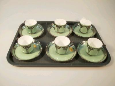 A set of six Minton's green ground coffee cans and saucers with Art Deco