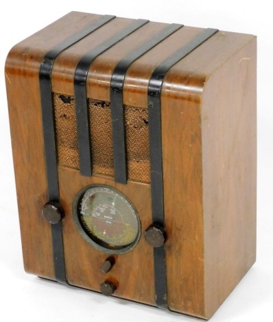 A Pye Art Deco walnut and ebonised radio, with Bakelite knobs, 41cm wide.