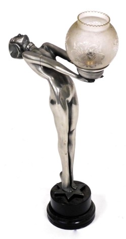 A metal finish resin Art Deco style table lamp, modelled in the form of a nude lady holding the fitting, on a circular base with star, 69cm high. (AF)