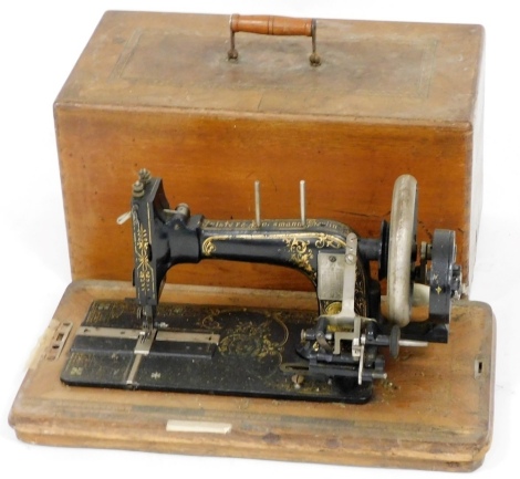 A Frister and Rossman sewing machine, with gilt decoration, serial no 882636, and inlaid case.