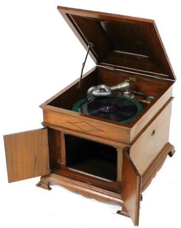An early 20thC Bassanophone gramophone, in mahogany and ebony strung case, with a two door sound box to the front, raised on ogee bracket feet, 41cm wide.