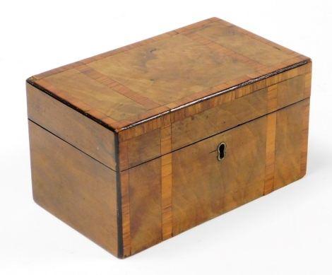 A 19thC walnut and satinwood cross banded tea caddy, of rectangular form, the hinged lid enclosing a twin lidded compartment interior, 17.5cm wide.