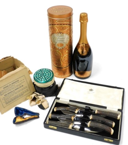 A bottle of Sainsburys Millennium Champagne, vintage 1995, with outer tin, a World War II respirator, dated April 1937, boxed, a set of six Mappin & Webb steak knives with simulated antler handles, and a miniature meerschaum pipe.