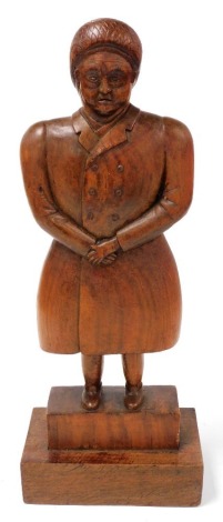 A Continental treen carving of a lady, possibly Ena Sharples, on a stepped base, 56cm high.