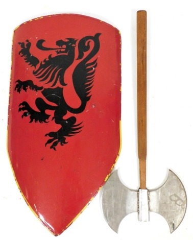 A painted metal shield, in red with stencilled dragon decoration, 83cm high, and a double edged axe.