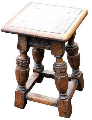 An oak joint stool in 17thC style, the rectangular top with a moulded edge, with a carved frieze on turned and carved supports, the top 47cm high, 33cm wide.