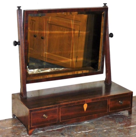 An early 19thC mahogany and satinwood cross banded dressing table mirror, with a rectangular bevel plate on reeded supports, the base with three drawers, on bracket feet, 56.5cm wide.