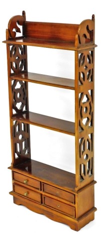 A Georgian style mahogany wall shelf, with pierced sides and an arrangement of four drawers, 107cm high, 50cm wide.