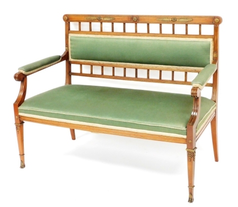 A continental mahogany and gilt metal salon sofa, with a padded back, arm rest and seat upholstered in green fabric, on square tapering legs, 112cm wide.