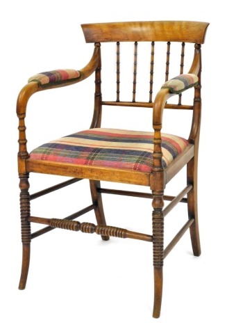 A 19thC beech open armchair, with spindle turned supports, padded arms and seat upholstered in tartan fabric, on ring turned and splayed legs.