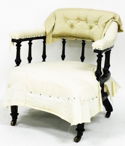 A Victorian ebonised and parcel gilt open armchair, with a padded back, arms and seat, on part fluted legs terminating in castors, 73cm high.