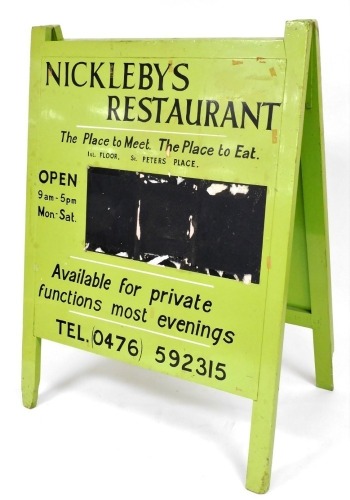 A green and black painted advertising A-board sign for Nickleby's Restaurant, St Peter's Place, Grantham, 140cm high, 101cm wide.