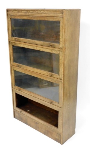 An oak solicitor's or library bookcase, with four glazed sectional doors and turned metal handles, 152cm high, 87cm wide.