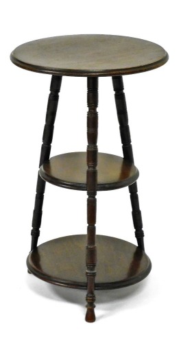 An Edwardian mahogany three tier gypsy type whatnot, each tier with a moulded edge, on turned supports, 62cm high, 38cm diameter.