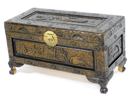 An Eastern carved camphorwood chest, decorated with birds, flowers, leaves, etc., 39cm high, 68cm wide, 34cm deep.
