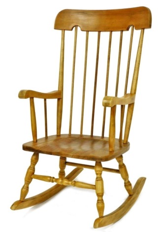 A hardwood rocking chair, with spindle turned back, solid seat on turned supports and stretchers.