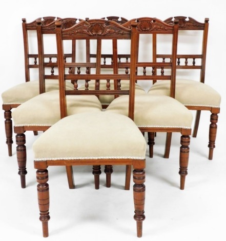 A set of six late Victorian walnut dining chairs, each with carved backs, green upholstered seats, 90cm high, 40cm wide, 55cm deep.