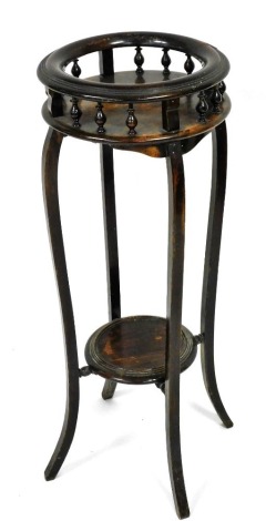 An ebonised beech plant stand, the circular moulded raised gallery, on spindle turned supports with splayed legs and under tier, 97cm high, 37cm diameter.