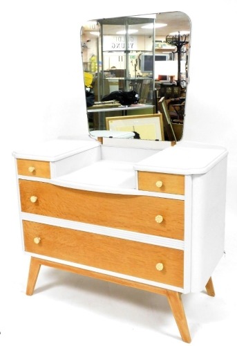 An oak and pale grey painted up-cycled dressing table, with stepped top, above two short and two long drawers, with early plastic handles and splayed legs, 101cm wide.