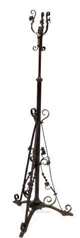 A late 19th/early 20thC brass adjustable floor lamp, decorated with flowers, scrolls, etc., in Art Nouveau style, converted to electricity, 145cm high. (AF)