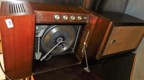 A mid 20thC Garrard teak cased record player, lacking legs, 67cm wide, and a Sanyo Otto speaker, 59cm high. Buyer Note: WARNING! This lot contains untested or unsafe electrical items. It is supplied for scrap or reconditioning only. TRADE ONLY