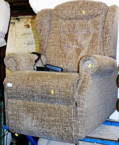 A Sherborne electric reclining armchair. The upholstery in this lot does not comply with the 1988 (Fire & Fire Furnishing) Regulations, unless sold to a known exporter or upholsterer it will be cut from the frame before leaving the premises.