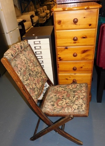 A narrow pine six drawer bedroom chest, 108cm high, 41cm wide, 38cm deep, a metal filing cabinet, and an upholstered folding chair.