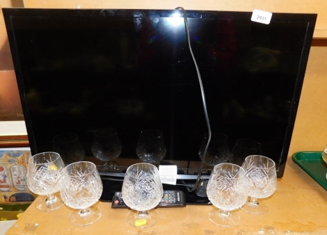 A Samsung 27'' television, UE28H4000, with lead and remote, and five brandy glasses.