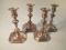 A set of four George V silver candlesticks of 18thC design by Mappin and Webb