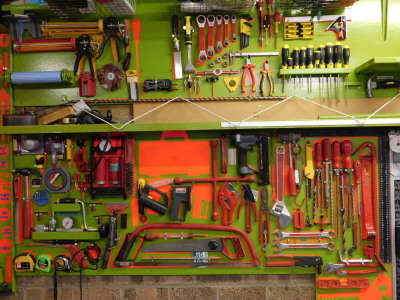 Various tools, to include screwdrivers, spanners, foot pump, hand saw, pliers, water pressure gauge, metal rules, joint and stud detector, short hammer, etc. Note: backing boards imaged are not included in the lot.