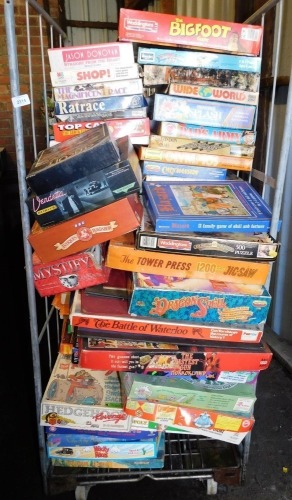 Various board games, puzzles, etc., to include Rat Race, Shop, The Big Foot Game, Wide World, Dad's Army, Dragon Speil, etc. (contents of 1 cage)