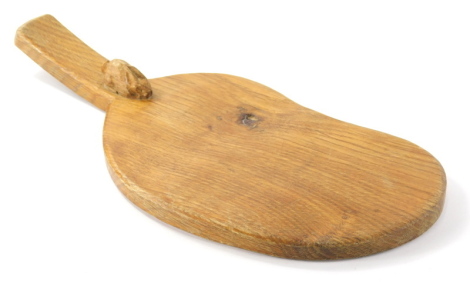 A Peter Heap of Wetwang Rabbitman oak cheese board, with carved rabbit, shaped body and plain handle, 35cm wide.