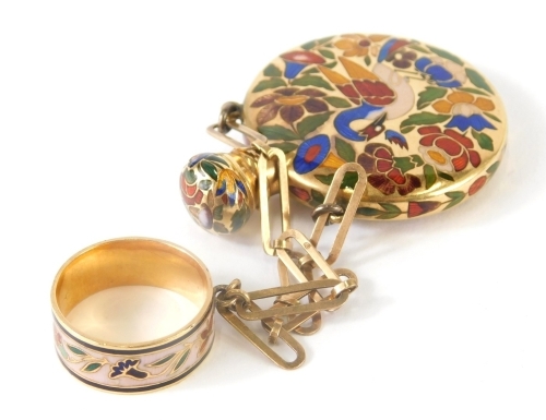 A 20thC enamel pendant scent bottle, with ring top and chain hanger, the circular body with compressed stopper enamelled with a bird and flowers, in blue, yellow, green and red, on a yellow metal ground, unmarked, the main body 4cm high.