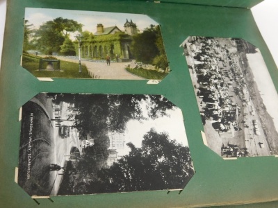 An album of early 20thC postcards, black and white scenes, views, mining card, figures on a bridge, cycling card On The Way To Blackpool, figures and groups, street scenes, figures in uniform, possible postal workers, Hartlepool and other street scenes, N - 4